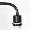 Steinhauer Lampadaire Bloeba à bras coudé orientable, abat-jour bleu, près du canapé